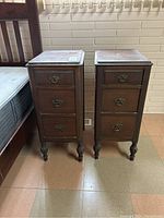 Two wooden nightstands side by side