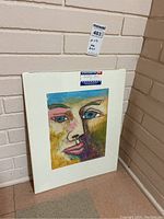 Frontal view of the matted artwork with a partial view of the signature and pastel texture