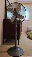Full view of Holmes Platinum oscillating pedestal fan with 5 metal blades and wire guard.