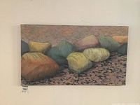 Full view of hand-painted batik artwork showing seashore with rocks and embroidered details.