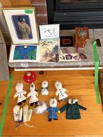 Overview of entire lot on wooden surface and fireplace hearth, showing framed prints, felt ornaments, wooden box, jewelry, and other indigenous-inspired decorative items.