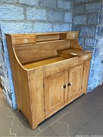 Front left three-quarter view of pine dry sink showing overall form and finish