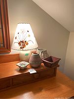 Lamp with crackle base, Dornbusch shade, signed vase, handmade basket, small wooden box on wooden surface