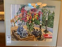 Frontal view of framed watercolor painting depicting floral still life on table