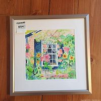Full view of the framed watercolor painting featuring flowers around a window with a cat on the windowsill.