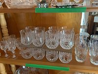 Multiple crystal glasses displayed including 17 high ball glasses with cut designs, 6 apritif glasses, and 4 water glasses.