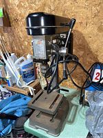 Front view of drill press showing base, table, column, and head assembly