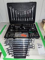 Full case with all tools displayed including combination wrenches inside the lid, sockets, ratchets, extensions and screwdriver in the base.