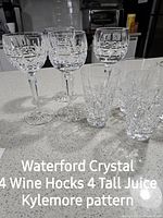 Eight cut crystal glasses (4 wine hocks, 4 tall juice) in Kylemore pattern displayed on countertop