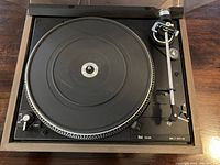 Top view of Dual 506 turntable showing black platter, tonearm, and speed control dial