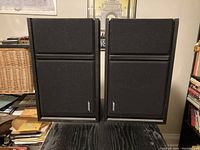 Front view of the pair of black Bose 301 Series III Direct/Reflecting stereo speakers with fabric grilles and Bose logo.