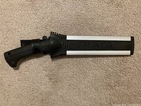 Silky NATA 240 black-handled cutting tool in sheath on carpet.