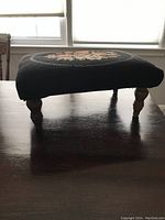 Side view of vintage wooden stool with turned legs