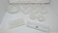 Photo showing the large and small dessert bowls, sugar bowl, creamer, dessert platter, and Shannon Crystal dish all together displaying cut crystal patterns.
