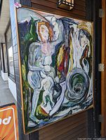 Large framed abstract painting with colorful, bold, and textured brush strokes depicting abstract figures and swirling shapes.