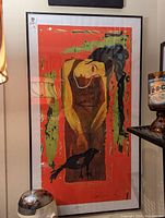 Full view of framed serigraph print showing a woman and bird against an orange background.