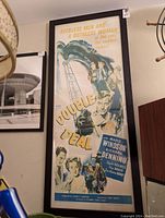 Framed 'Double Deal' movie poster sized about 16x38 inches, showing characters and text including lead actors and catchphrase.