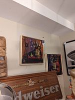 Photo showing two framed mid-century original artworks hung on a wall displaying abstract colorful compositions.