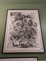 Framed black and white signed art print showing abstract surrealistic shapes and figures in intricate detail.