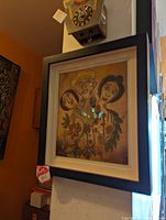 Photo of framed original signed painting depicting three stylized women and floral motifs