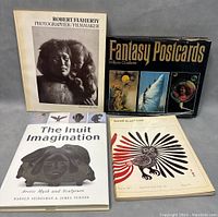 Photo showing the front covers of four books: "Robert Flaherty Photographer/Filmaker", "Fantasy Postcards" by William Ouellette, "The Inuit Imagination", and an Inuit art print book.
