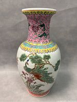 Full view of the porcelain vase showing its shape and painted designs.