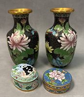 Pair of cloisonne enamel vases and two cloisonne trinket boxes side by side showing overall condition and design.