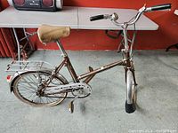 Side view of vintage Dawes bike showing overall frame, saddle, rear luggage rack, and rear reflector.