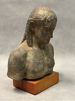 Side angled view of Apollo bust statue showing detailed curls and facial features.