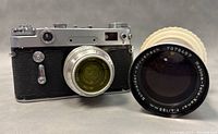 Front view of Soviet Union analog camera with Kodak lens and Schneider-Kreuznach Retina Tele-Xenar lens beside it