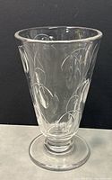 Front angle view of the clear crystal vase showing the engraved floral pattern and flared top with footed base.