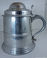 Front and side view of the tin/aluminum beer stein with pewter handle and lid.