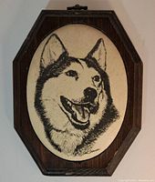 Front and center view of the octagonal wooden plaque with beaded glass husky image, showing signature.