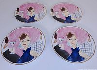 Top view of four oval Lenox Kate Spade plates showing illustrated cocktail woman design and pink background