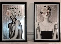 Two framed prints together, showing female portraits with flowers over faces on metallic silver backgrounds.