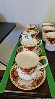 Four Royal Albert Old Country Roses teacups and four matching saucers, one cup is a different style, displayed on a table