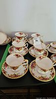 Set of six Royal Albert Old Country Roses teacups and matching saucers displayed on a table.