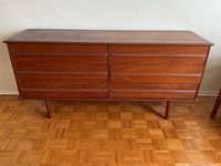Front view of walnut veneer dresser showing six drawers and tapered legs