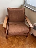 Front view showing full chair with brown cushions and teak frame