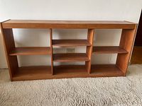 Front view showing full open shelving unit against wall