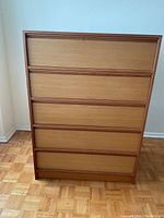 Front view of five-drawer chest