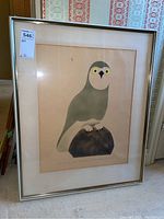 Full view of framed owl stencil artwork against patterned wallpaper