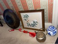 Full lot view showing gong, framed art, tea jar, and teapot