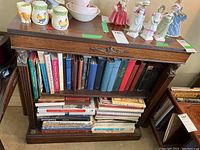 Front view of bookcase loaded with books and decorative items (contents not included)