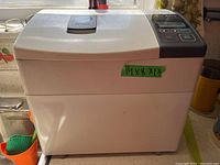 Front and side view of Panasonic bread maker showing its size and lid design.