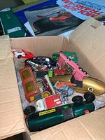 Box containing several vintage and wooden toy cars and a wooden carriage, showing variety of items and condition with some paint chips.