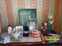 Group arrangement of all decorative items against patterned wallpaper