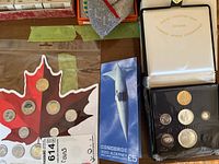 Overview of three coin sets: Canada 150 blister card, Concorde 2003 Alderney card and two Royal Canadian Mint cases