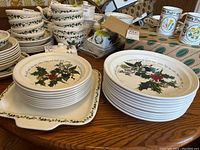 Stack of smaller and larger plates with tray on wood table