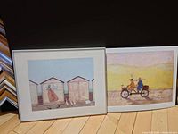 Photo of two Sam Toft artworks side by side on the floor, one framed and one mounted on mat board.